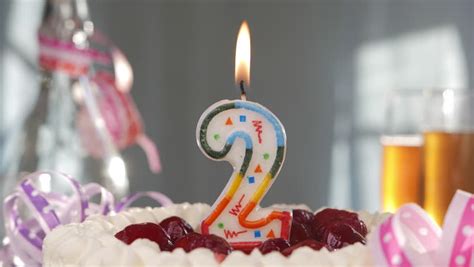 Birthday Candle Number Two Burning On Top Of Cake Stock Footage Video