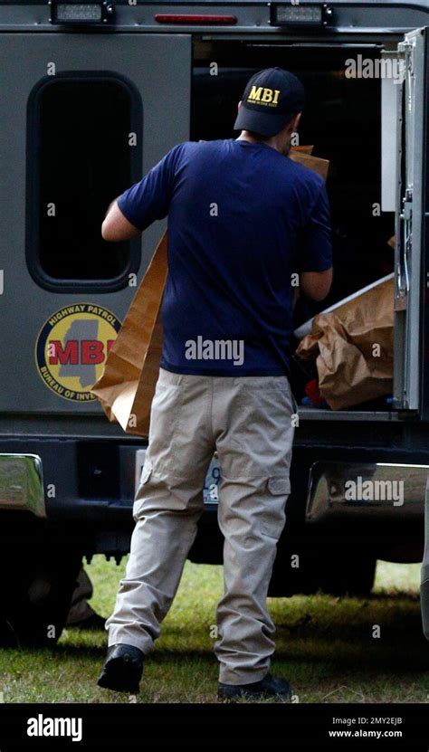 A Mississippi Bureau Of Investigation Agent Stores Evidence Bags From