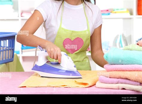 Young Girl Ironing In Room Stock Photo Alamy