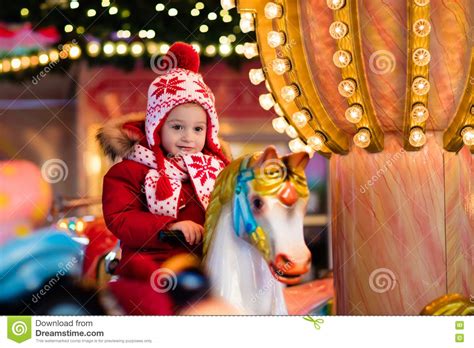 Child Riding Carousel On Christmas Market Stock Image Image Of Baby