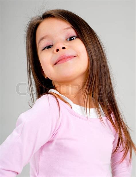 Portrait Of A Cute Smiling Cheerful Baby Girl With Long Brown Hair