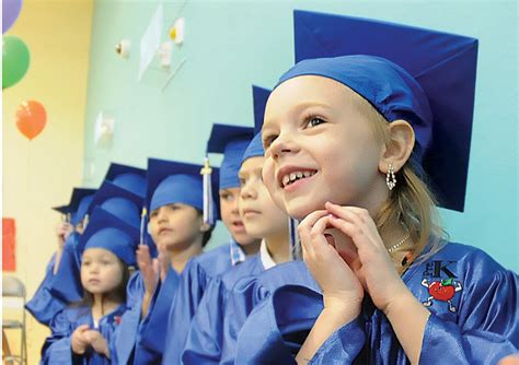 Happy First Steps Pre Kindergarten Students Don Cap Gowns For