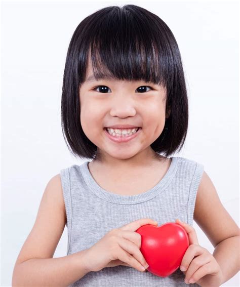 Asian Little Chinese Girl Holding Red Heart Hope And A Future