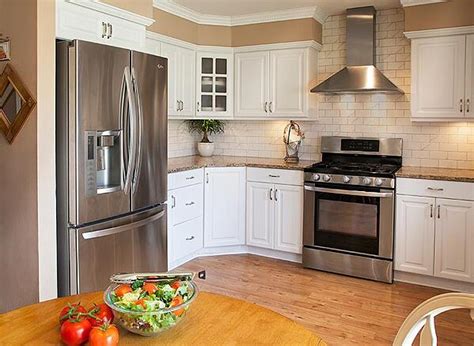 The white kitchen island and all white accessories—sans the sunny yellow mixer—add to the airy feel. Which Paint Colors Look Best with White Cabinets?