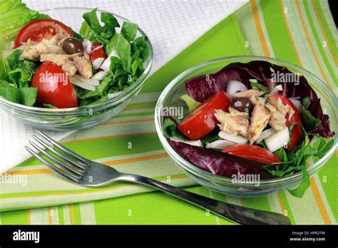 Lettuce Tomato Olive And Mackerel Summer Salad Served In Glass Bowls