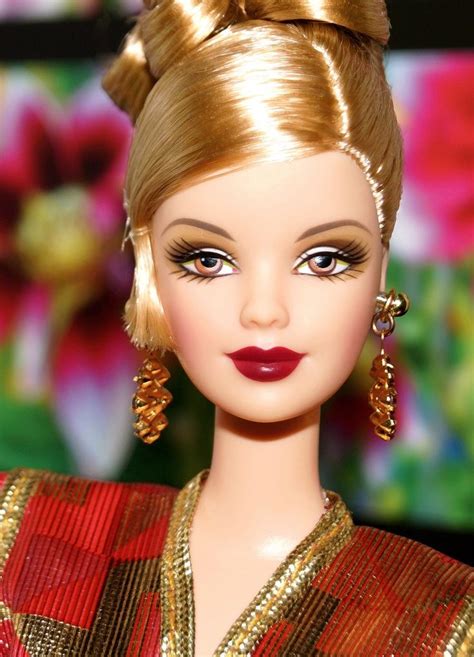 a close up of a barbie doll with blonde hair and gold jewelry on her head