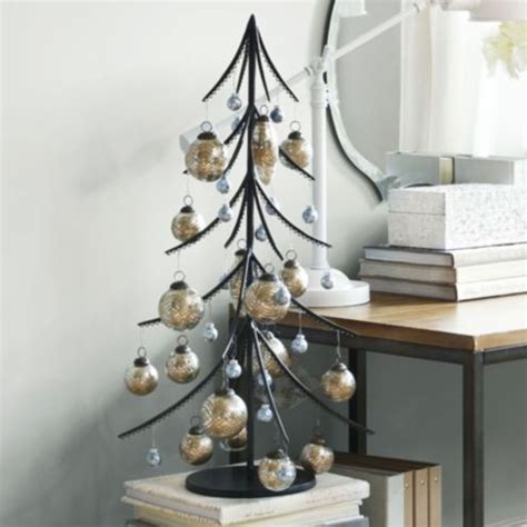 A long wrought iron tree with many branches can be used as a coat tree. Iron Ornament Tree | Ballard Designs