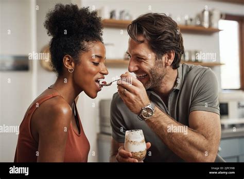 Romantic Happy And Interracial Couple Eating A Healthy Yogurt Together