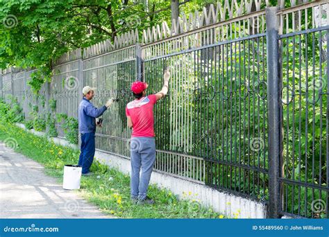 Two Workers Painting A Metal Fence Editorial Image Image Of