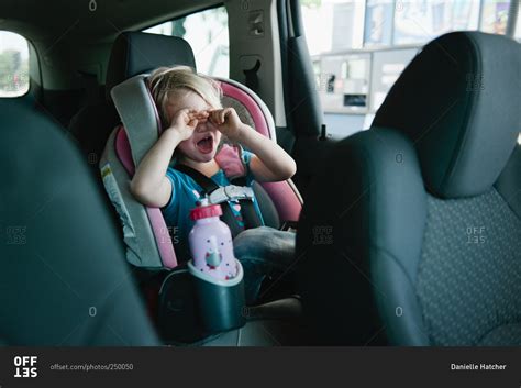 Young Girl Strapped In A Car Seat Having A Crying Tantrum Stock Photo