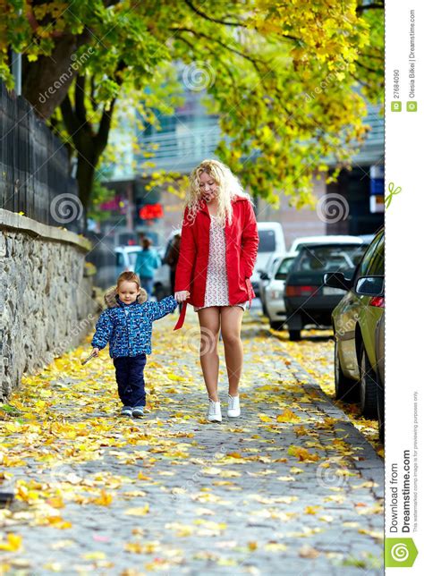 Young Mother And Son Walking Urban City Street Stock Photo