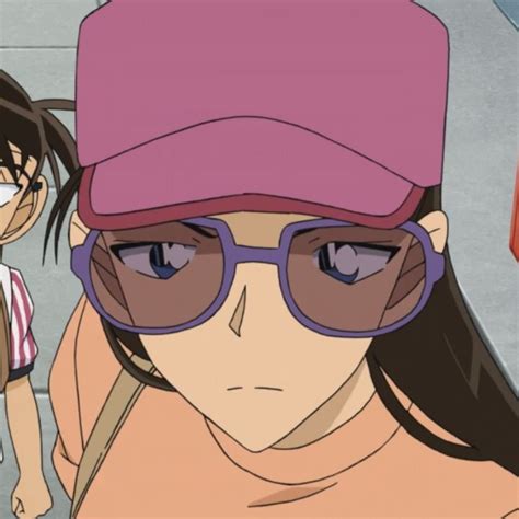 An Anime Character With Glasses And A Pink Hat Is Standing In Front Of Another Character