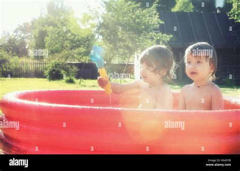 Baby Splashing In The Pool Outdoors Stock Photo Alamy