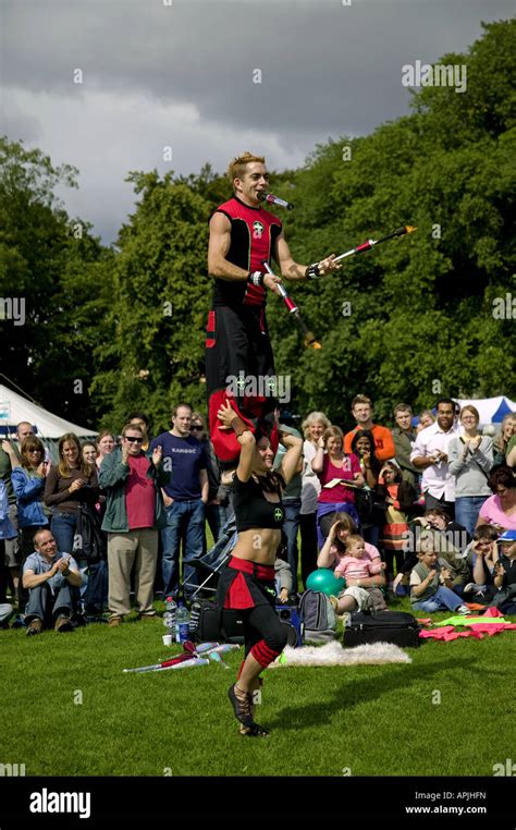 Male Balancing On Females Shoulders While Juggling Fire Torches
