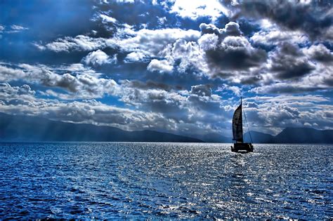 1920x1080 Resolution Black Sailing Boat Under Cumulus Clouds On Body