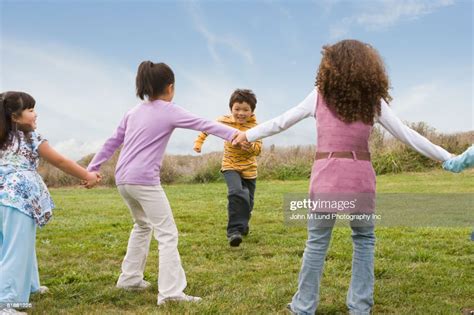 Multiethnic Children Playing Game In Field High Res Stock Photo Getty