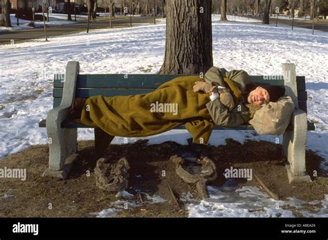 Homeless Man Age Sleeping On Park Bench St Paul Minnesota Usa Stock
