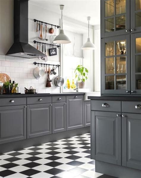 The grey of this kitchen island contrasts the bright white of the cupboards while the backsplash adds a bit of color to the room. Remodelaholic | Decorating With Black: 13 Ways To Use Dark ...