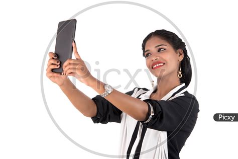 Image Of Pretty Young Indian Girl Taking Selfies In Smart Phone On An
