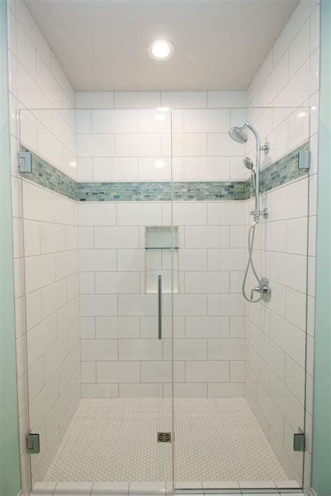 white tiled shower with aqua mosaic accent strip and glass shower door bathroom remodel