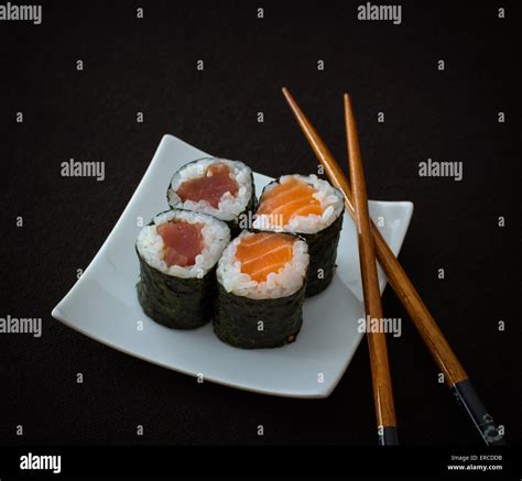 Salmon Tuna Maki Sushi And Chopstick On Black Top View Stock Photo
