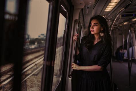 women standing in train holding metal rail while looking outside 5k hd girls 4k wallpapers