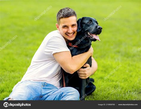 Guy Hugging His Dog Labrador Playing Park Stock Photo By ©osons163