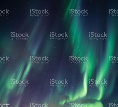 Aurora Borealis Northern Lights With Stars Glowing In The Night Sky