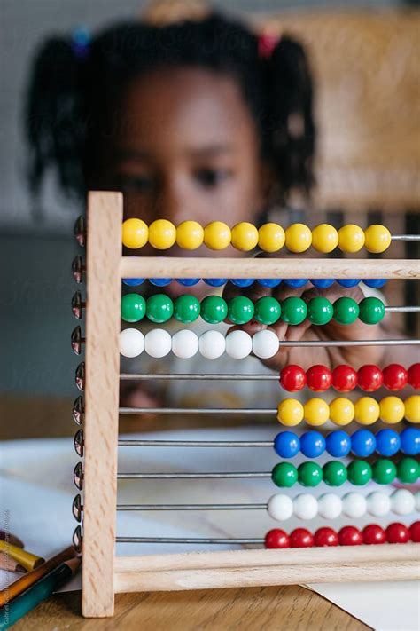 View African American Girl Using An Abacus In Classroom By Stocksy