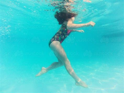 Image Of Girl Floating Underwater In A Pool Austockphoto