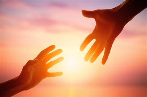 Giving A Helping Hand On The Background Of The Dawn Stock Photo