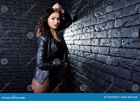 Studio Portrait Of Brunette Girl In Black Leather Jacket Stock Photo