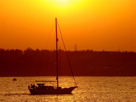 Gray Sailboat On Body Of Water During Golden Hour Hd Wallpaper