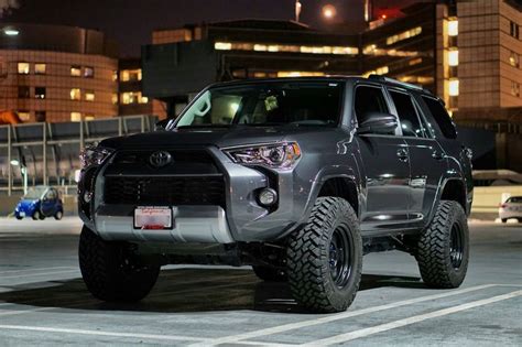 A Gray Toyota 4runner Is Parked In The Parking Lot At Night With Its