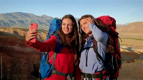 Two Girls Do Selfie On The Phone Against The Landscape By Stocksy Contributor Nikita Sursin
