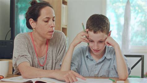 Mother Helping Her Son To Do His Homework At Home Stock Video Footage