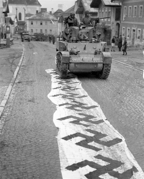 11th Armored Division M5 Stuart Runs Over Captured German Flags Lembach