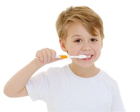 A Little Boy Is Brushing His Teeth With A Toothbrush Stock Image