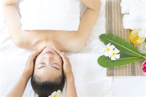 Young Asian Beautiful Woman Getting Facial Treatment And Enjoying Massage In Spa Salon Stock