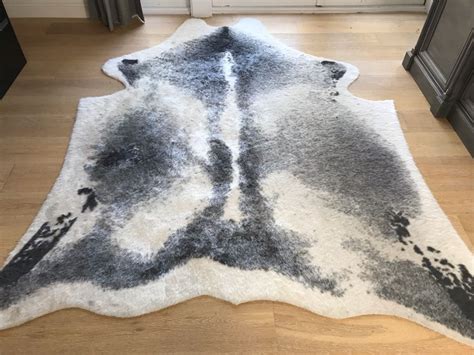 This faux fur statement rug is a stylish layering option, but also offers a soft seat on otherwise hard chair seats. Faux Animal Hide Area Rug Silhouette Home Ivory Grey 6.2' X 8'
