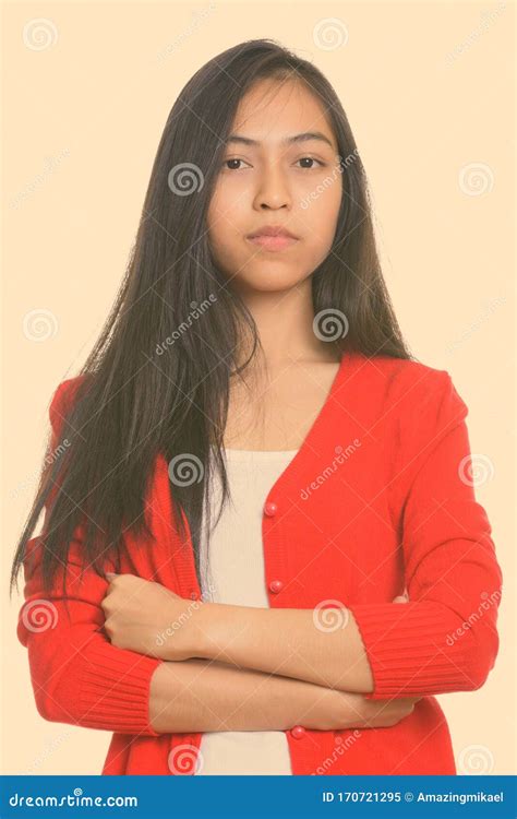 Studio Shot Of Young Asian Teenage Girl With Arms Crossed Stock Image