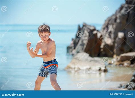 Cute 7 Years Old Boy Having Fun On Tropical Beach Stock Photo Image