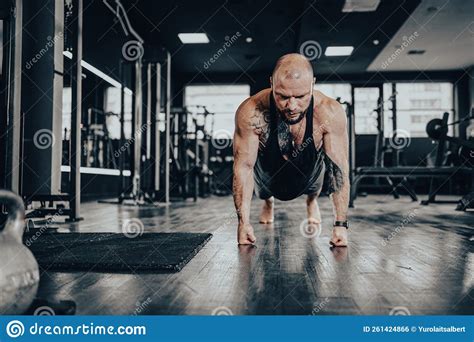 Male Bodybuilder Performing Push Ups On His Fists Stock Photo