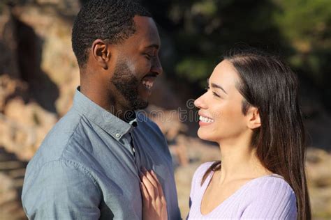 Interracial Couple In Love Looking Each Other Outdoors Stock Image