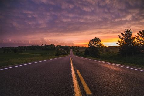 Photo Of Empty Road In Between Grass Field During Golden Hour · Free