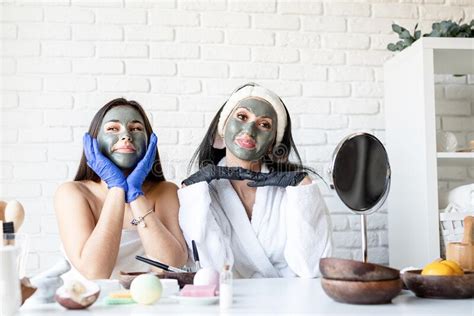 two beautiful women in gloves applying facial mask having fun stock image image of healthy