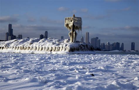 A harbor light is covered by snow and ice on the Lake Michigan at 31st