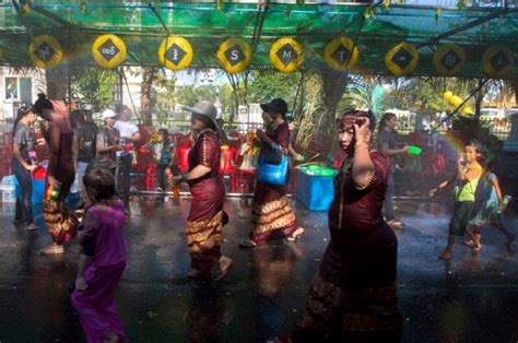 Soaked Streets And Water Fights For Myanmar New Year Festival Coconuts