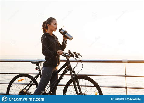 Photo Of Caucasian Woman Drinking Water While Riding