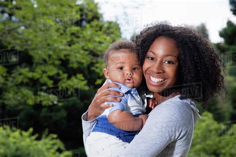 African American Mother Holding Baby Son Stock Photo Dissolve